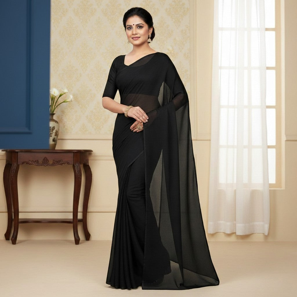 Shafusion black georgette plain saree with matching blouse worn by a woman in a festive indoor setting