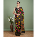Shafusion black georgette saree with vibrant floral and polka dot prints, worn by a model with traditional jewelry.