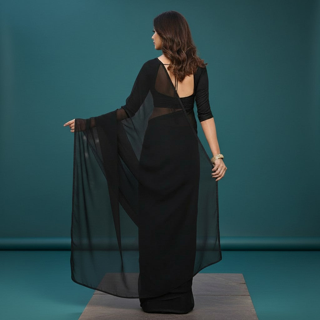 Shafusion black georgette saree worn by a woman, showcasing the sheer fabric and matching blouse from the back view.