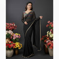 Shafusion black fox georgette saree with a multicoloured chevron pattern blouse, worn by a model among flower pots.