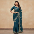 Shafusion blue georgette saree featuring intricate gold embroidery and an unstitched blouse worn by a model.