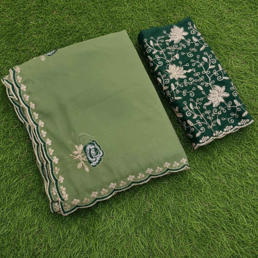 Shafusion green star georgette saree with intricate floral embroidery and matching unstitched blouse on green grass