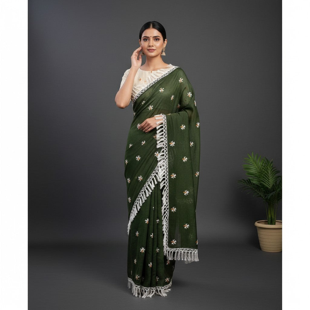 Shafusion green georgette saree with white floral embroidery and fringe trim, worn with a cream unstitched blouse.