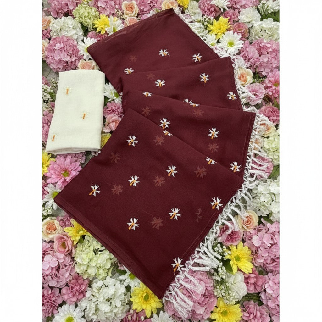Shafusion maroon georgette saree with white floral embroidery and tassel trim, paired with an unstitched blouse.