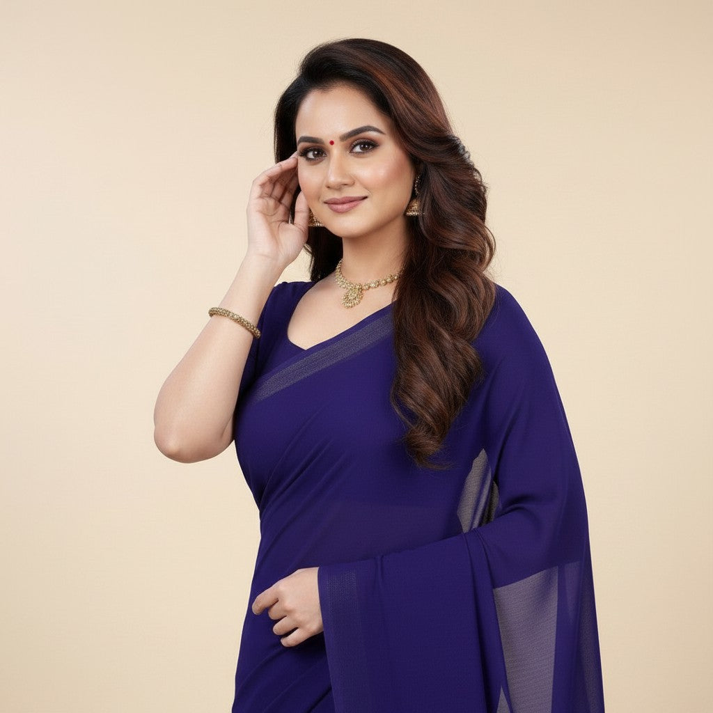 Shafusion navy blue georgette plain saree worn by a woman with traditional gold jewelry for festive occasions