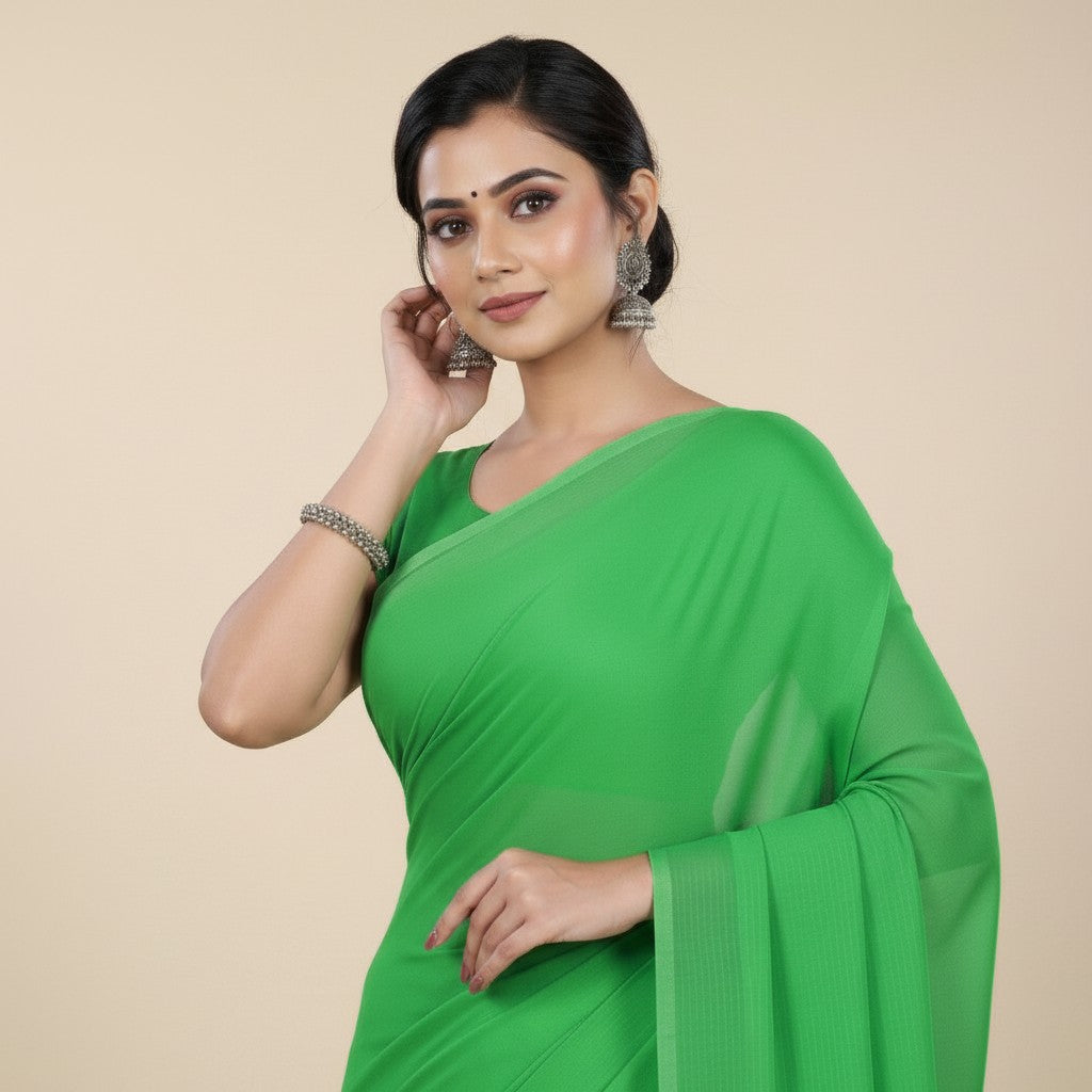 Shafusion parrot green georgette plain saree worn by a woman with traditional silver jhumka earrings and bracelet
