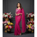 Shafusion pink fox georgette solid saree with a patterned unstitched blouse worn by a model in a floral studio setting