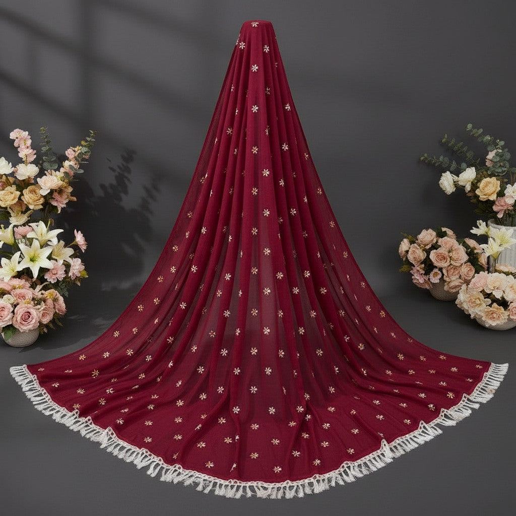 Shafusion pink georgette saree with floral embellishments and white tassel fringe, displayed with floral arrangements.