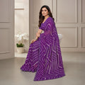 Shafusion purple georgette saree with white geometric print worn by a woman sitting on a chair