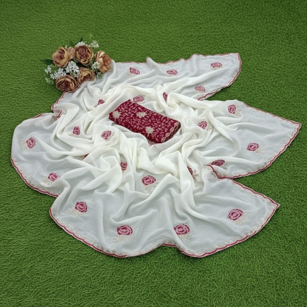 Shafusion white star georgette saree with red floral embroidery and matching unstitched blouse on green grass