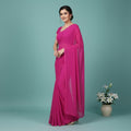 Shafusion wine georgette plain saree worn by a woman, featuring a matching blouse for casual and festive wear.